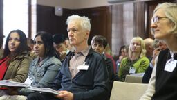 An audience listening to a presentation