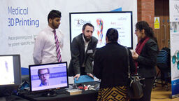 A group having a conversation at the Insigneo showcase 2017.