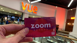 hand holding a card which says zoom beyond