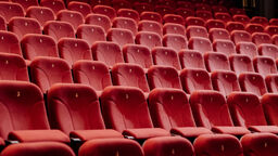 Rows of empty red seats in a cinema