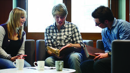 A photo of students reading and discussing