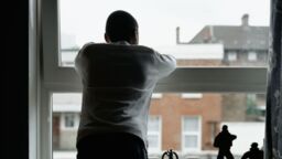 Young person looking out the window.