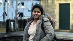 Jahanavachandrika Kotha wearing a grey puffer coat and smiling