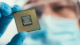 Stock image of researcher holding up chip