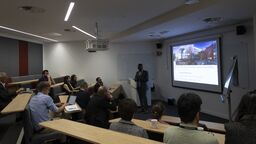 Academics and researchers sat in a lecture theatre.