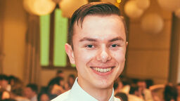 A white man in a shirt and bow tie
