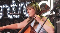 Student university alumni playing a cello 