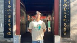 Photo of a Maths student standing by a decorative doorway