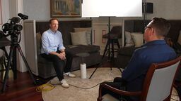 Documentary interview with two men facing each other