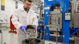 Sam Lister fills a FAST-Forge mould with titanium swarf