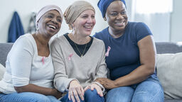 Group of women wearing breast cancer awareness badges