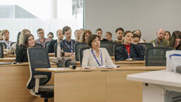 Lada Price sat at the front of a seated group of conference attendees watching a presentation