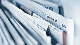 some newspapers in a holder