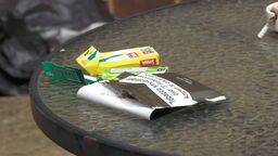 Crumpled tobacco packet and filters on a table