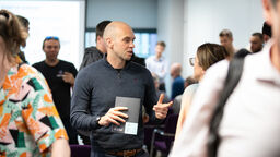 Group of people talking at an event