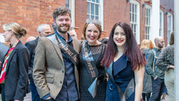 three people wearing 'KE and Impact awards' sashes.