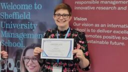 Rachael Green holding a Best paper award certificate.
