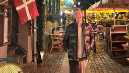 Student Ollie Thompson stood on a street in Copenhagen in the evening