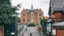 A person is walking in front of the law building on campus