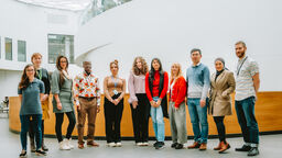 COP29 delegates standing in a row in the Wave 