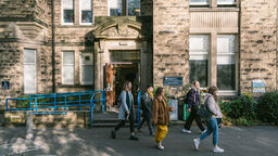 Front of Elmfield building with students walking outside