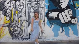 Jess standing in front of graffiti