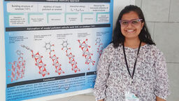Manasi Mulay standing in front of her research poster