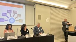 Photo of a panel including Naomi Hawkins