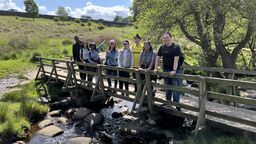 Students pose for a photo on a bridge at Padley Gorge in the Peak District
