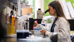 Student using a microscope in the lab