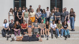 Informal group photo of about 30 students in summary dress 