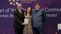 Erica on stage being presented with an award