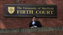 Hao MSc graduate in front of Firth court 