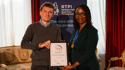 Jason Slade receiving the Patsy Healey Award from Helen Fadipe