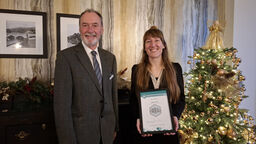 PhD student receiving a certificate