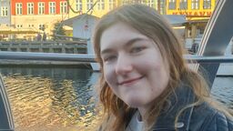 Student Megan Swanson smiling next to a river.