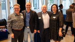 A group of alumni smiling for a picture at an alumni event