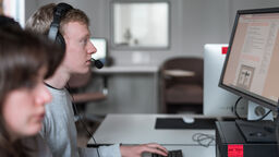 A person attending an online meeting using a desktop computer