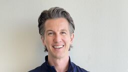 White man smiling at camera