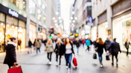 Blurred image of people walking around a shopping centre