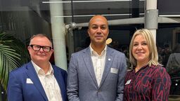 Three people smiling at the camera.