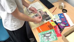 Aaron reviewing items in the Special Collections archive