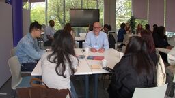 Groups of people sat around tables