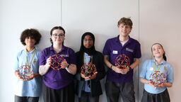 A group of people, holding a Buckyball 
