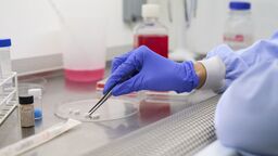 A person looking at a sample in a lab.
