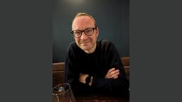 Professor Malcolm Tait against a dark grey background