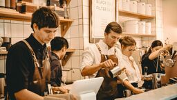 Young cafe workers preparing coffee 