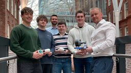 Aerospace engineering students holding their 3D printed research