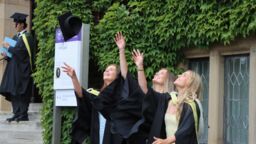 Management graduates throwing their hats class of 2026