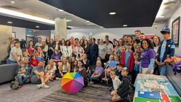 A group of people smiling in a room.